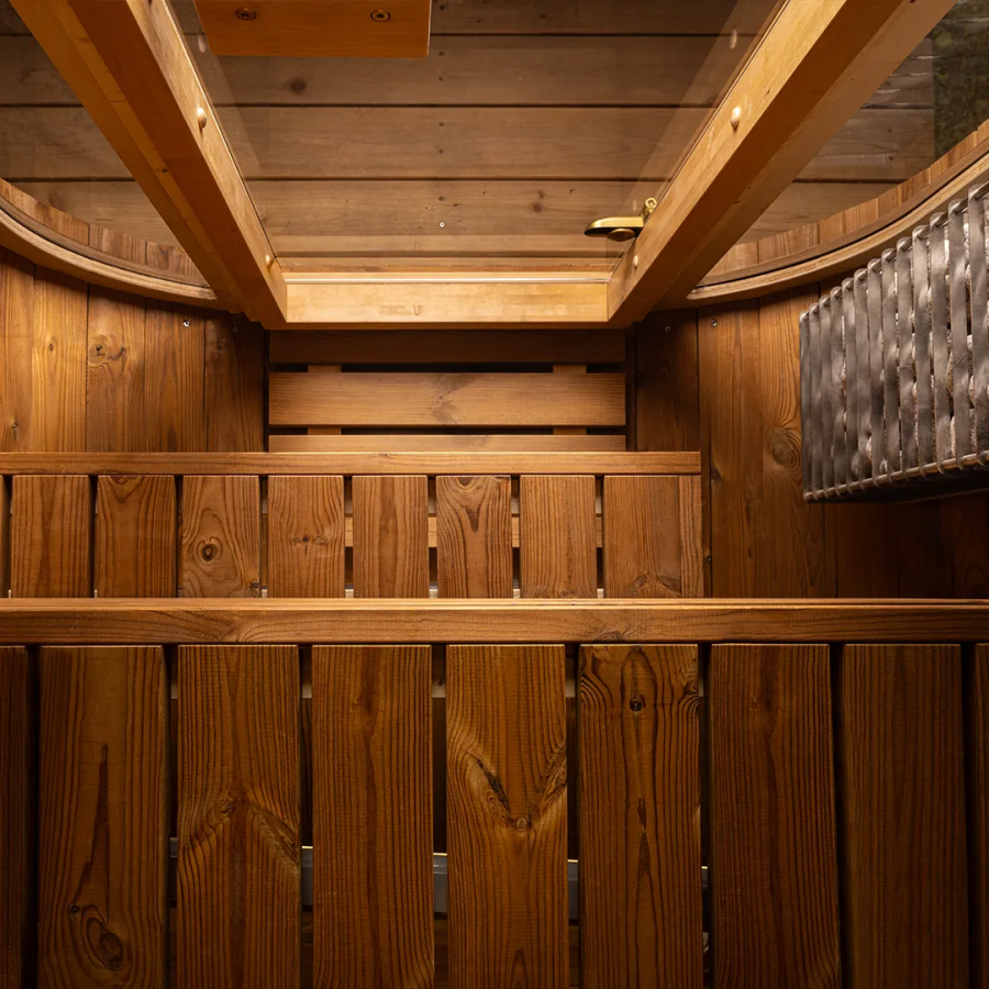 Warm cedar sauna interior with integrated heater and bench seating