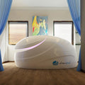 Dreampod V2 flotation tank shown from the left side in a bright wellness room with large windows
