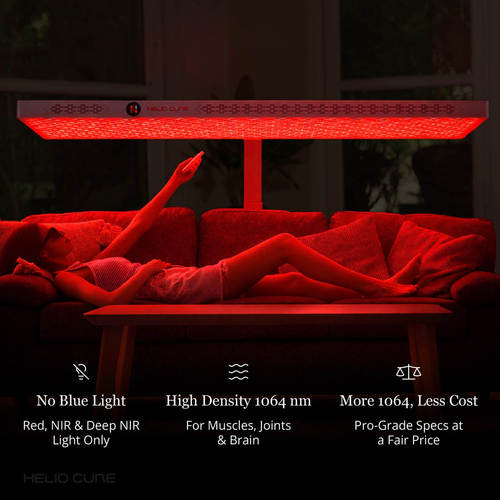 Woman relaxing on a couch beneath a horizontal Helio Nova red light therapy panel for full-body wellness and recovery.