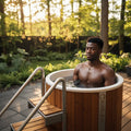 Icetubs IceBarrel XL cold plunge tub with wooden access steps on backyard patio.