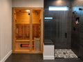 Indoor infrared sauna fitted into a custom bathroom wellness retreat with a frameless glass shower and modern finishes