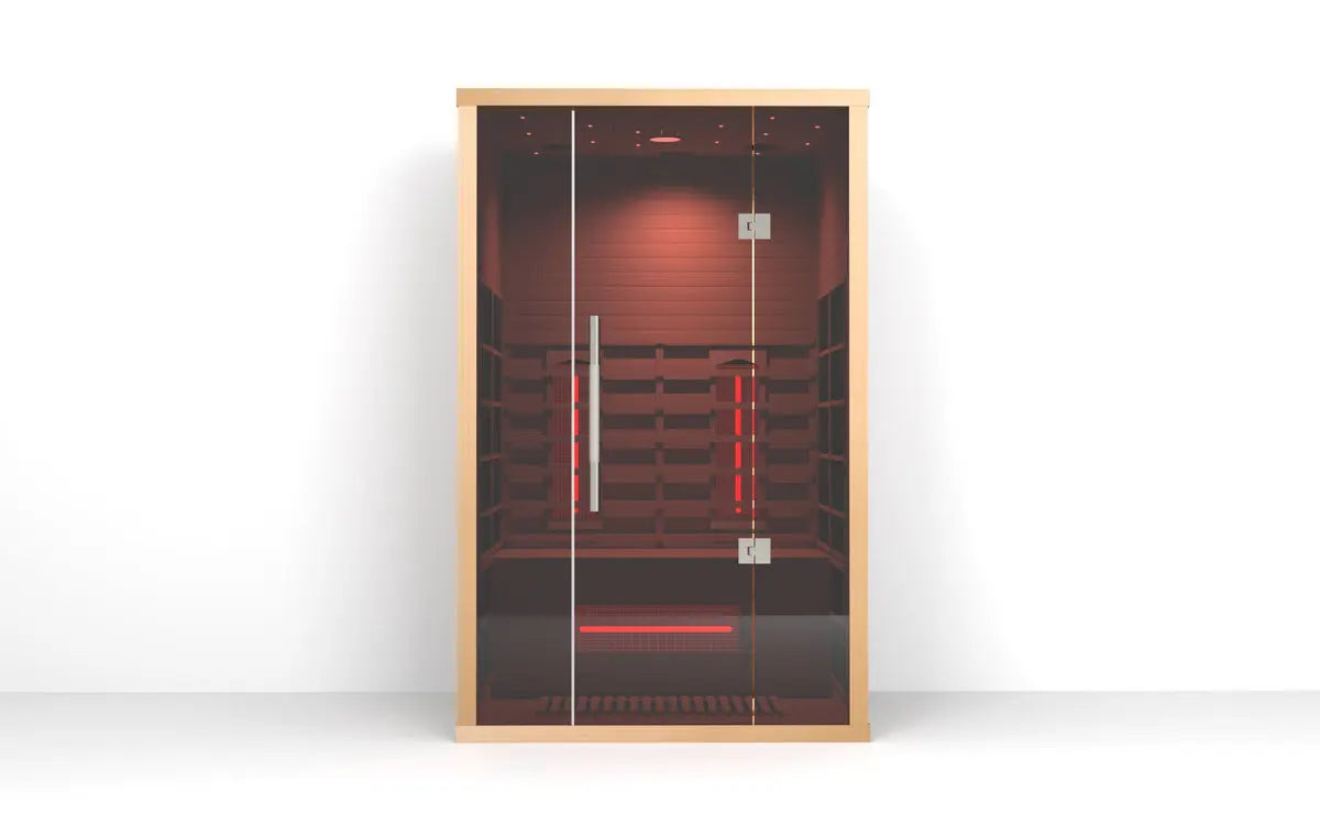 Studio view of the Orivon Lumin Two infrared sauna with warm red light filling the hemlock interior.