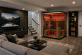 Rövia Ember 4-person full-spectrum infrared sauna installed in a modern finished basement with sectional seating and home entertainment area.